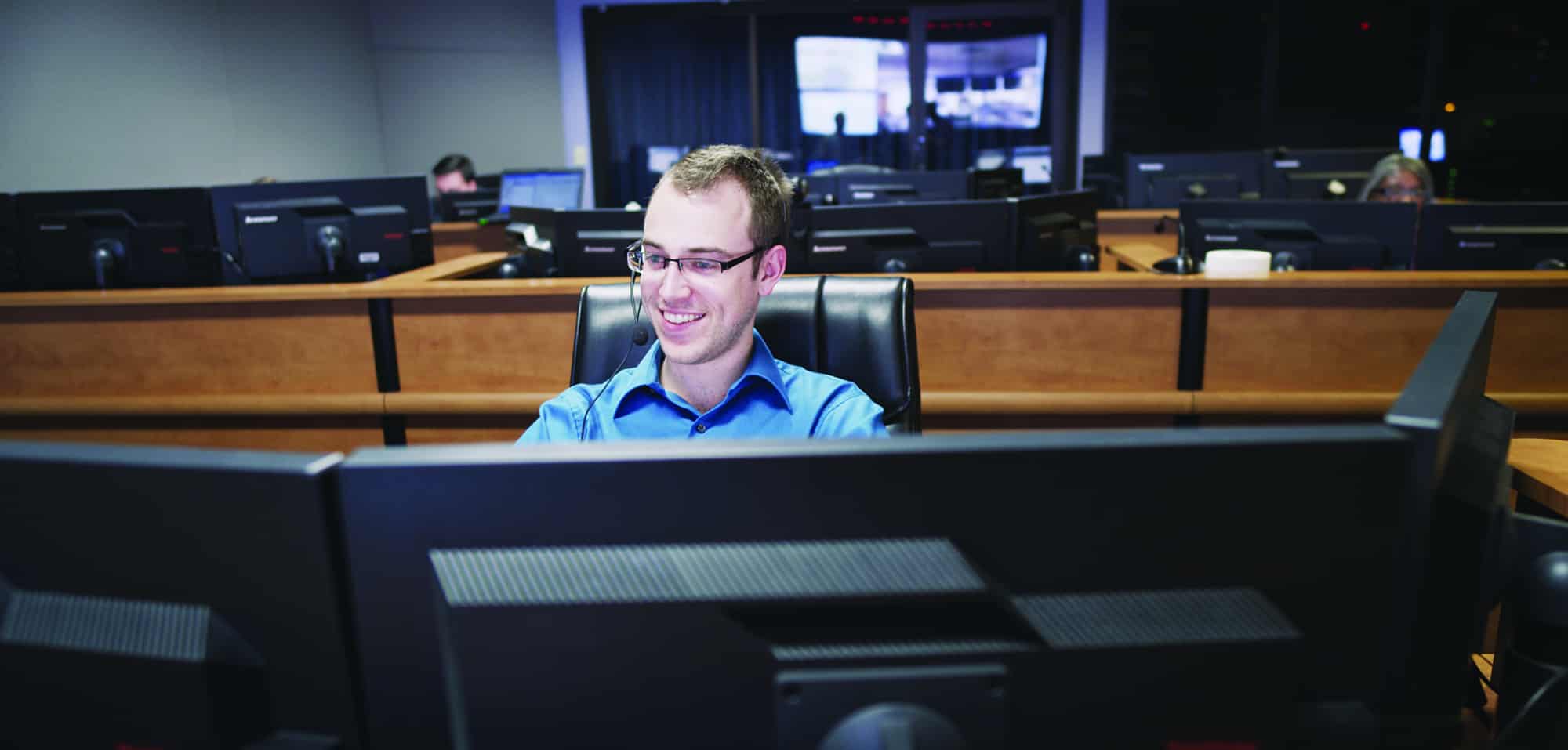 24/7 technology help desk support staff member at desk