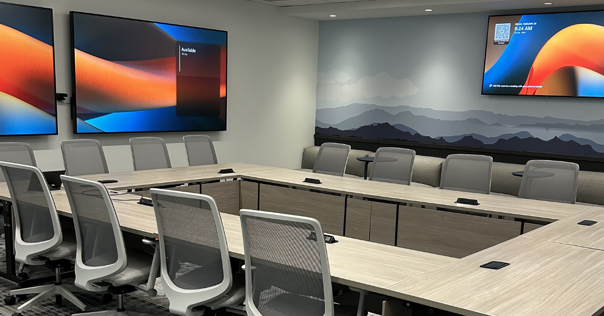 Large IDRC conference room featuring Microsoft Places room scheduling functionality on displays.